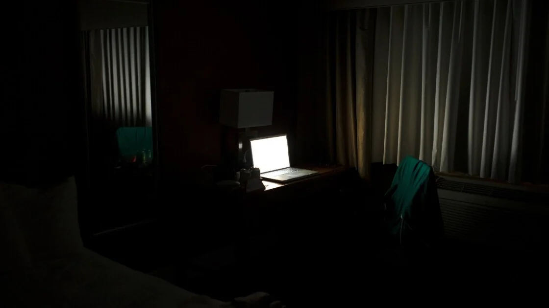 A Windows computer awake at night while the user is in bed.