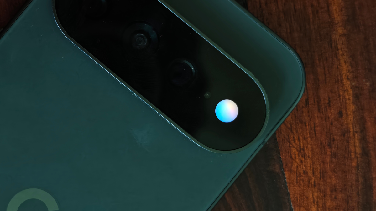 Close-up of a Pixel 11 phone showing the Gemini indicator on its camera bar.