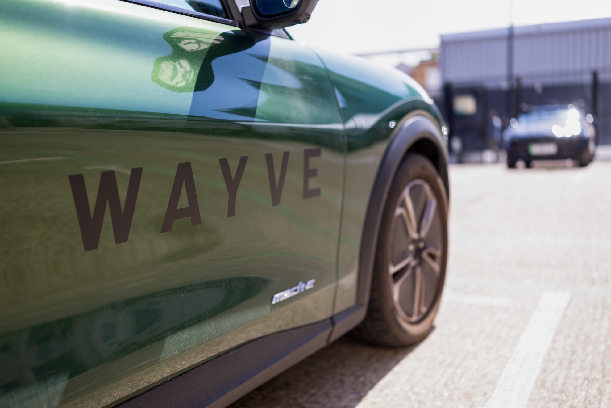 A Wayve autonomous-driving test vehicle on a city street.