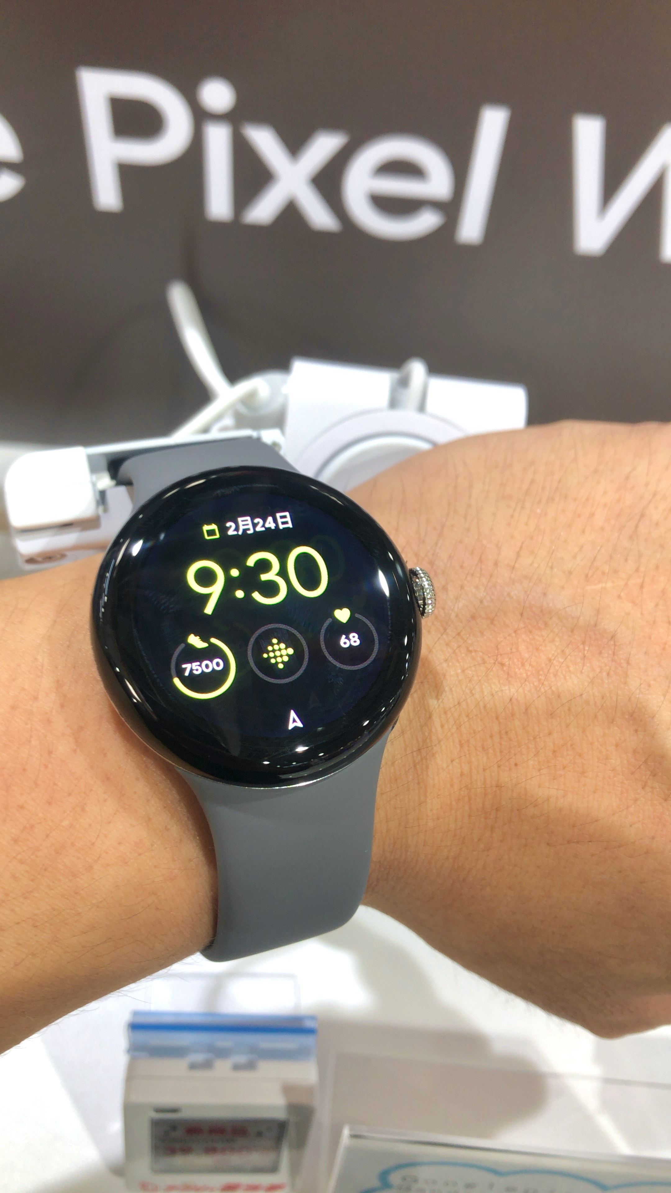 A Google Pixel Watch displayed with its circular screen and black band.