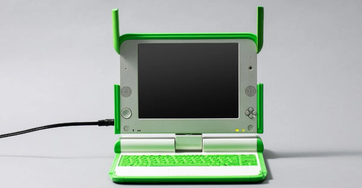 Green-and-white OLPC XO-1 laptops shown for The Verge's Version History retrospective.