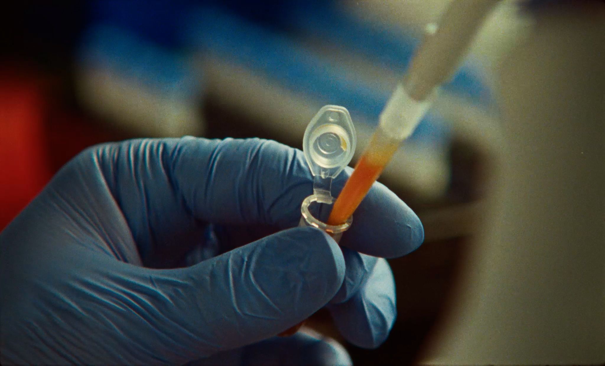 A scientist pipetting in a laboratory.