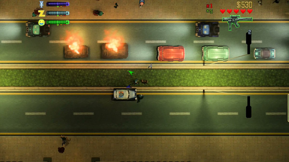 GTA 2 gameplay shows burning cars casting light onto a city street through an RTX Remix mod.