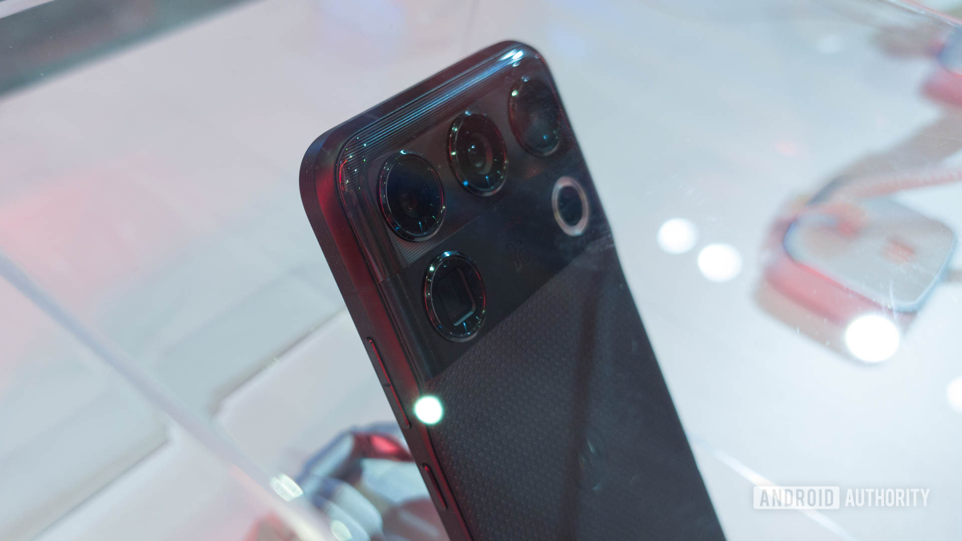 Rear camera array of a Motorola Signature 27 phone displayed under glass.