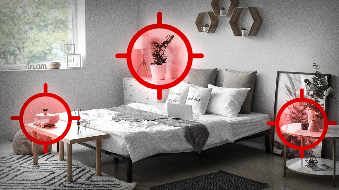 A small hidden camera lens being inspected in a room.