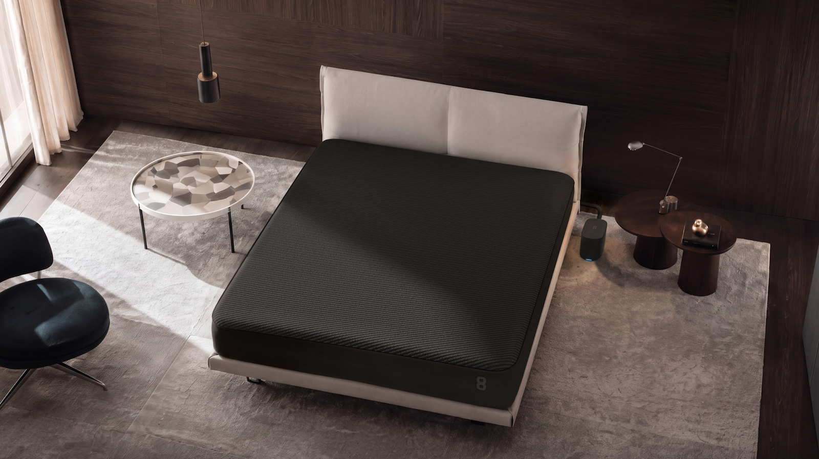 Eight Sleep Pod 6 mattress cover and compact cooling hub beside a bed.
