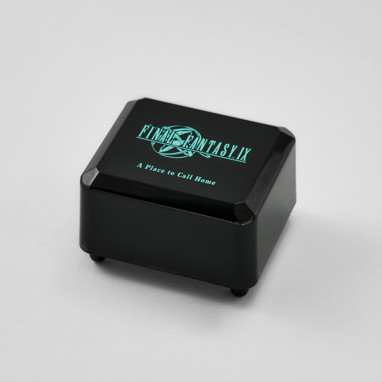 A black Final Fantasy IX music box with “A Place to Call Home” printed beneath the game logo on its lid.