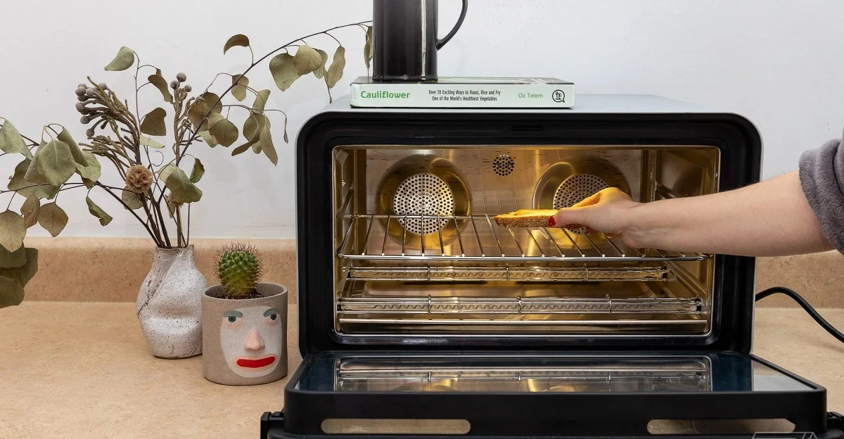 A June connected countertop oven with its touchscreen illuminated.