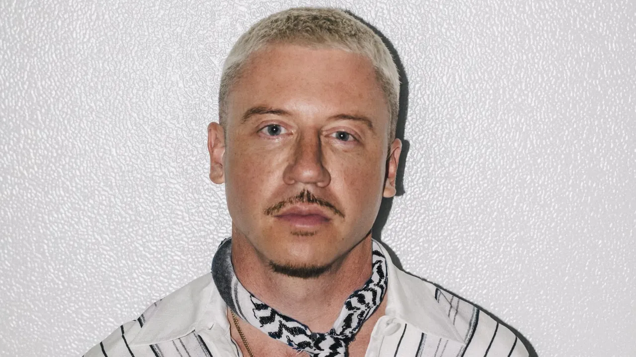 Macklemore wears a keffiyeh in a portrait.